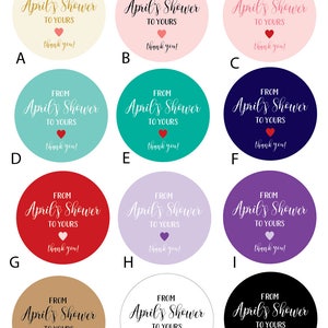 May include: Twelve round favor tags with the text "From April's Shower to Yours" in gold script with a small red heart. The tags are in various colors: beige, pink, teal, red, purple, light purple, brown, white, and black.