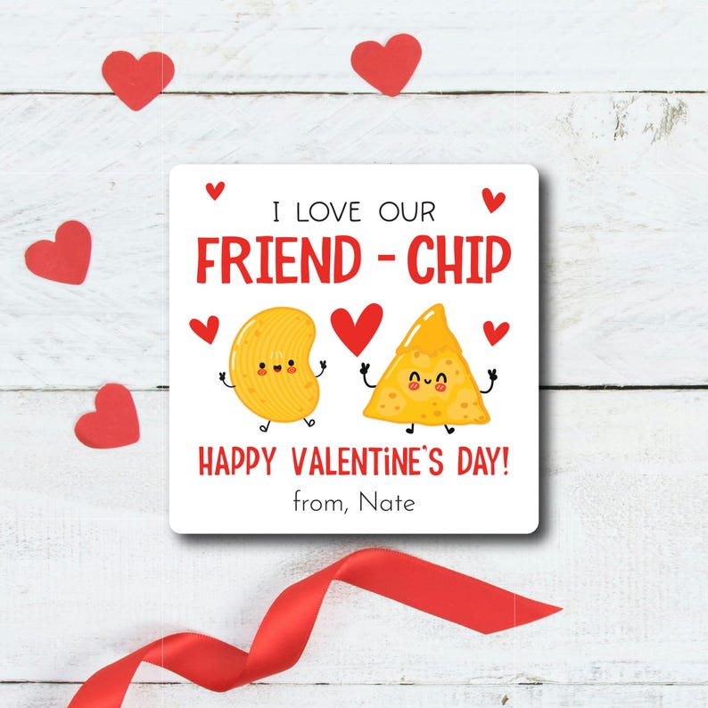 May include: A white card with a red heart and the text "I love our friend-chip Happy Valentine's Day! from, Nate" with a cartoon chip and a cartoon french fry.