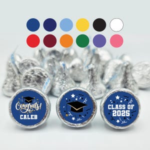 May include: Blue and gold graduation party favor stickers with a graduation cap, stars, and confetti. The stickers say "Congrats! Caleb" and "Class of 2025".