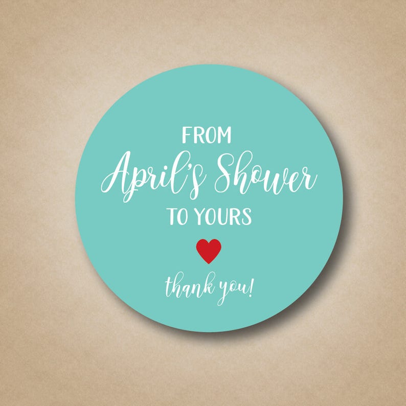 May include: A turquoise round sticker with white text that reads "From April's Shower to Yours" with a red heart and the words "thank you!"