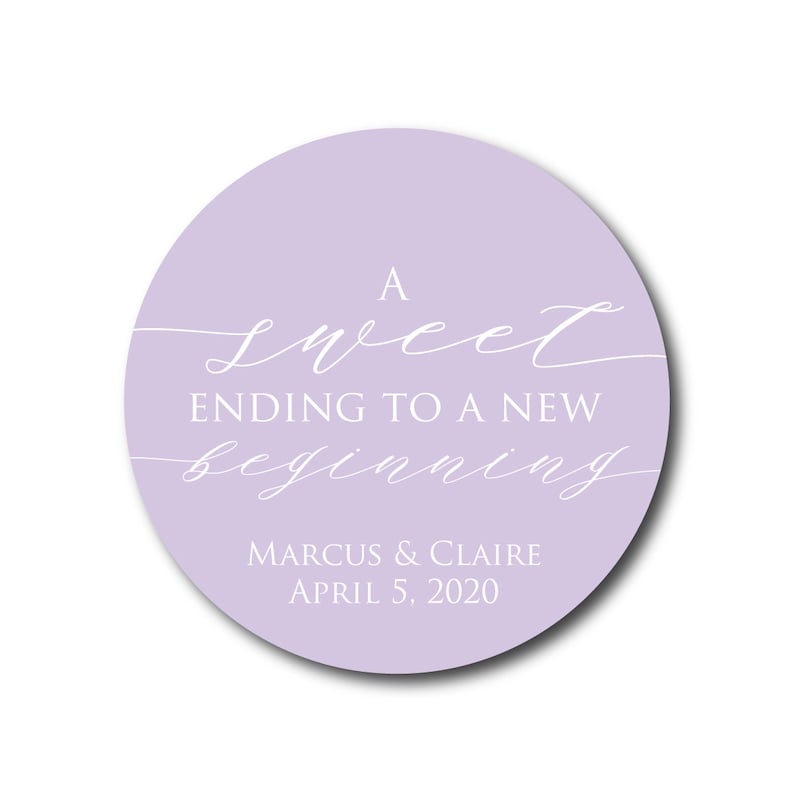 May include: A lavender circle sticker with the text "A sweet ending to a new beginning" in white script font. Below the text is "Marcus & Claire April 5, 2020" in white sans-serif font.