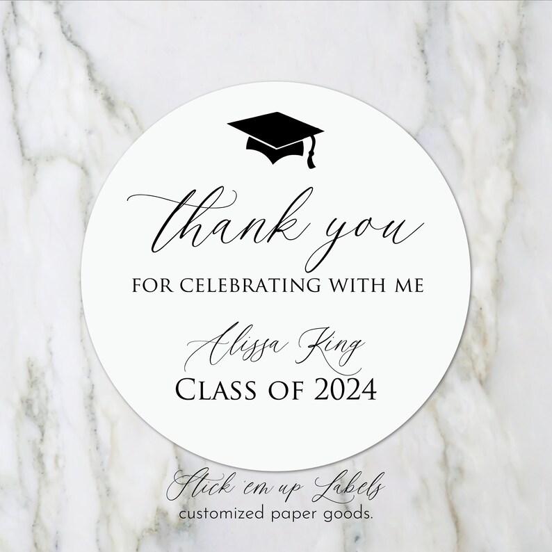 May include: Round white sticker with black text and a graduation cap graphic. The text reads "Thank you for celebrating with me Alissa King Class of 2024". The bottom of the sticker reads "Stick em up Labels customized paper goods."