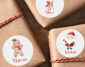 May include: Three wrapped gifts with decorative stickers. One sticker features a reindeer with a red scarf and the name "Alice". Another shows a gingerbread man with the name "Marcus". The third sticker depicts Santa Claus with the name "Tristan".