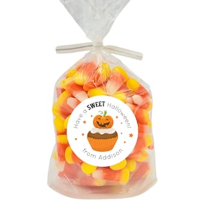 May include: A white circle sticker with a pumpkin cupcake illustration and the text "Have a SWEET Halloween! from Addison".
