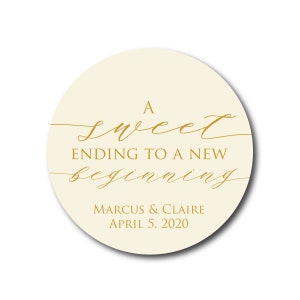 May include: A round, cream-colored sticker with gold lettering that reads "A sweet ending to a new beginning" and "Marcus & Claire April 5, 2020".