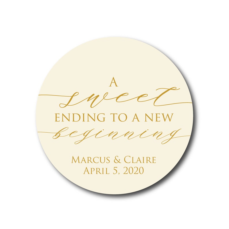 May include: A round, cream-colored sticker with gold lettering that reads "A sweet ending to a new beginning" and "Marcus & Claire April 5, 2020".