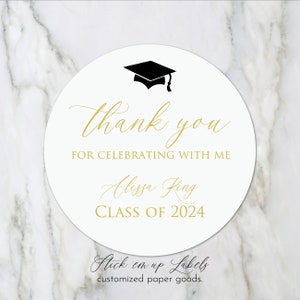 May include: White round sticker with gold text that says "thank you for celebrating with me Alissa King CLASS OF 2024". A black graduation cap is at the top of the sticker. The text "Stick em up Labels customized paper goods." is at the bottom of the sticker.