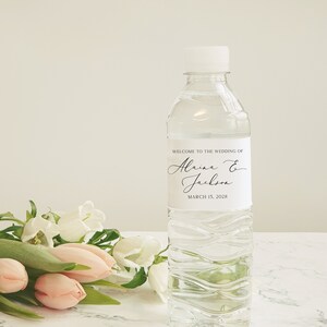 May include: A clear plastic water bottle with a white label that says "Welcome to the wedding of Alaina & Jackson March 15, 2028".