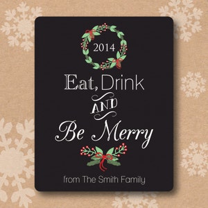 May include: Black and white Christmas card with a green wreath, red berries, and the text "Eat, Drink and Be Merry" with the year 2014. The card also includes the text "from The Smith Family".