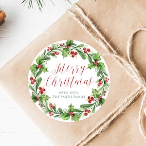 May include: Round Christmas gift tag with a watercolor wreath of green holly leaves and red berries. The text reads "Merry Christmas" in red cursive lettering and "With Love, The Smith Family" in black lettering.