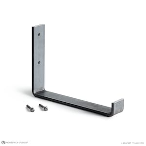 May include: A raw steel J-bracket featuring a vertical mounting plate with two circular screw holes and a horizontal support arm with an upturned end. Two matching metal screws are positioned separately next to the bracket.