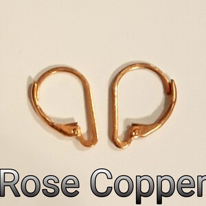 May include: Two rose copper leverback earring findings. The findings are a warm, reddish-orange color. The text "Rose Copper" is displayed in a black font at the bottom of the image.