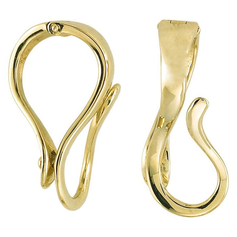 May include: Two gold-colored jewelry clasps. One clasp is closed, showing a curved, looped design with a small hinge. The other clasp is open, revealing a similar curved shape with a hook. Both clasps have a polished finish.