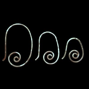 May include: Three silver-toned, wire-formed earrings with a spiral design. The earrings are arranged from largest to smallest, with a hammered texture. The hooks are curved and the spirals are at the bottom.