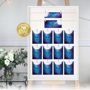 May include: A white board with a pink ribbon and 12 blue and purple moon table cards with white numbers. The board is on an easel and has a gold sticker with the text "Personalize with CORYL" on the left side. The cards have a white moon with a starry background.