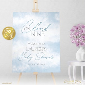 May include: A blue and white watercolor baby shower sign with the text "On Cloud Nine" and "Welcome to Lauren's Baby Shower August 17, 2024".