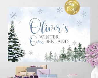 Può includere: Un cartello rettangolare con una scena di bosco invernale ad acquerello con pini innevati e fiocchi di neve. Il testo recita Oliver's WINTER ONEDERLAND in caratteri blu e grigi. Un badge circolare dorato riporta PERSONALIZE WITH Corjl.