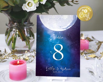 May include: A blue and purple table number card with a white moon and stars. The number 8 is in white and the text reads "Table 8, Kaitlyn & Andrew, 6.15.2024".