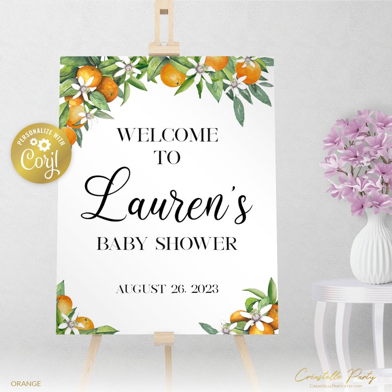 May include: Welcome to Lauren's Baby Shower sign with orange blossoms and leaves. The sign is white with black text and the date August 26, 2023.