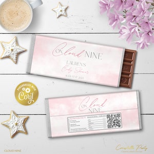 May include: Pink and white chocolate bar wrapper with the text "On Cloud Nine" and "Lauren's Baby Shower" with the date August 17, 2024. The wrapper has a watercolor-like design with a QR code on the back.