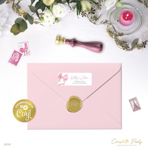May include: A pink envelope with a gold wax seal and a label that reads "Kaitlyn Wilson". A pink bow is on the label. A pink wax stamp and a gold wax stamp are also visible. The word "BOW" is at the bottom.