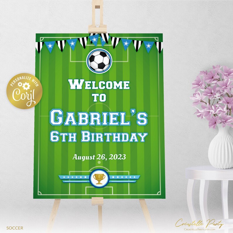 May include: Green and white soccer field welcome sign with a blue banner that says "Welcome to Gabriel's 6th Birthday" and the date "August 26, 2023".