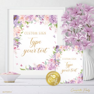 May include: Two printable signs with a floral border in shades of purple and pink. The signs have the text "CUSTOM SIGN Type your text" in gold lettering.