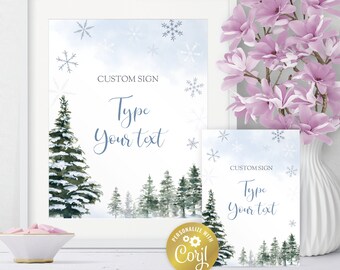 May include: A white framed sign and a smaller matching card featuring a winter forest scene with snow-covered pine trees, blue watercolor sky, and snowflakes. The text reads CUSTOM SIGN and Type Your text. A gold circular Corjl logo is included.