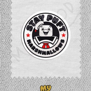 May include: A white and black circular patch with the text "Stay Puft Marshmallows" and a cartoon image of a marshmallow man with a red bow tie and a sailor hat. The text "Stay Puft" is in a black font and the text "Marshmallows" is in a white font. The background is a white canvas with a gray pattern.