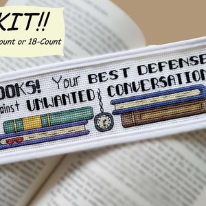 May include: Cross-stitch kit with a bookmark design. The text reads "BOOKS! Your BEST DEFENSE Against UNWANTED CONVERSATION." The design includes stacked books and a pocket watch. Available in 14-count or 18-count.