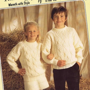 May include: A knitting pattern for a white sweater and skirt. The pattern is called "Snow Goose" and is made with "Peregrine" yarn. The pattern is for sizes 61, 66, and 71 cm.