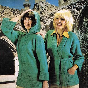 May include: Two women wearing green knitted cardigans. The cardigan on the left has a hood and a pocket on the front. The cardigan on the right has a tie belt and pockets on the front. The cardigans are a textured knit with a waffle stitch. The text on the image reads "Argyll Double Knitting 871 Code A To Fit Sizes 86-97 cm Bust (34-38 inch)"