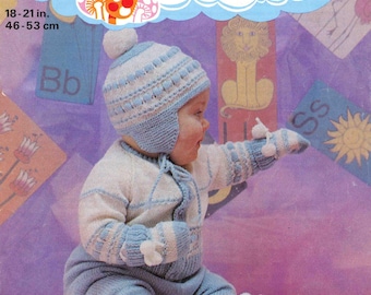 May include: A baby wearing a light blue and white knitted outfit, including a hat, sweater, pants, mittens, and booties. The outfit is designed with a striped pattern and a pom-pom on the hat. The image includes the text "PATONS FAIRYTALE" and measurements of 18-21 inches and 46-53 cm.