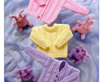 May include: Image of children's knitwear patterns. The image features a pink cardigan, a yellow sweater, and a purple cardigan. The cardigans have button closures. The image also includes plush bunny toys. The text "Wondersoft DK" and "Stylecraft" are visible.