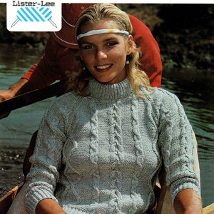 May include: A light blue Aran knit jumper with a high neck and cable knit pattern. The jumper is being worn by a woman with blonde hair and a headband. The text "K1775" and "ARAN QUALITIES" is visible in the image. The text "Lister-Lee" is also visible in the image. The text "BUST 81-86-91-97 cm. (32-34-36-38 ins.)" is visible in the image.