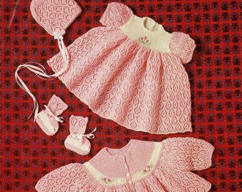 May include: A vintage knitting pattern featuring a baby dress, bonnet, and booties in pink. The pattern is for a 3-ply yarn and fits a 18-19 inch (46-48 cm) chest. The pattern is titled "Fairytale" and includes the brand name "Patons".