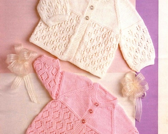 May include: Two knitted baby cardigans, one cream and one pink, with diamond and openwork patterns. The cream cardigan is on top, and the pink one is below. The image includes the text "Peter Pan 4 Ply" and measurements of 16-18 inches.