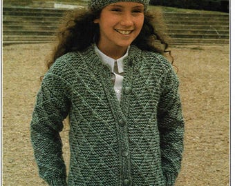 May include: A green knitted cardigan and matching hat. The cardigan has a diamond pattern and button closure. The hat is a beanie style. The image also includes the text "PATONS" and "Beehive Chunky".