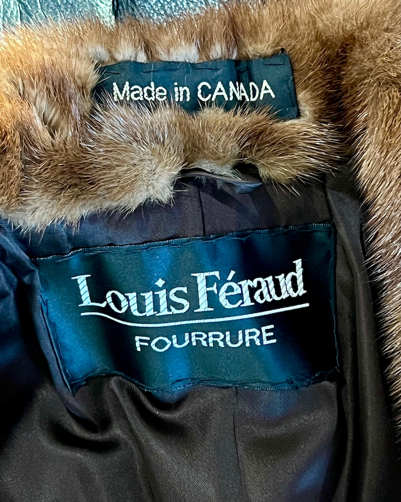 May include: A brown fur coat with a black label that reads "Louis F&eacute;raud Fourrure" and a smaller label that reads "Made in CANADA".