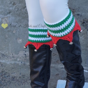 May include: A pair of black boots with red and green crocheted boot cuffs with bells. The cuffs have a striped pattern.