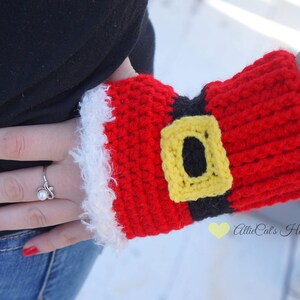 May include: Red and white crocheted fingerless gloves with a black belt and yellow buckle. The gloves are designed to look like Santa Claus's outfit. The text "AllieCat's Hats and Crafts" is visible in the lower right corner of the image.