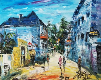 May include: A colorful oil painting depicting a street scene with buildings, trees, and people walking. The buildings are painted in shades of blue and white, while the trees are green and the people are wearing various colors. The street is paved with a yellow and orange color.