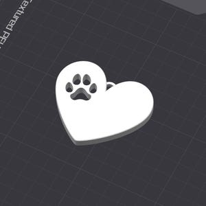 May include: White ceramic heart-shaped pendant with a paw print cutout. The pendant is a 3D design and has a smooth, glossy finish.