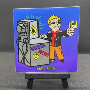 May include: A cartoon sticker of a character wearing a red jacket, sunglasses, and roller skates. The character is standing in front of a computer with the text "Hack the Planet" and "Jolt Cola" on it. The character is giving a thumbs up and holding a floppy disk. The sticker has the text "Zero Cool" at the bottom.