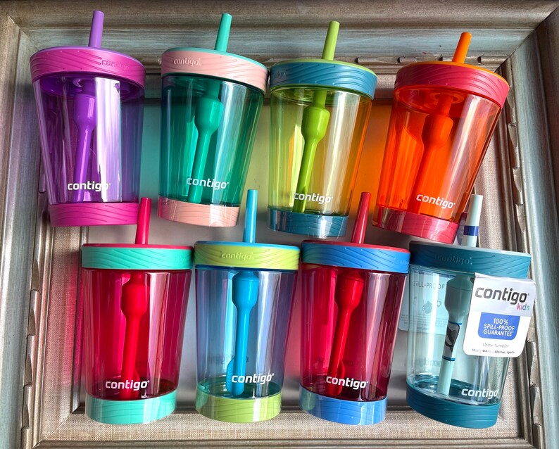 May include: Eight colorful Contigo Kids spill-proof cups with built-in straws. The cups are made of clear plastic with a variety of colors and designs. The cups are all 100% spill-proof and have a built-in straw.