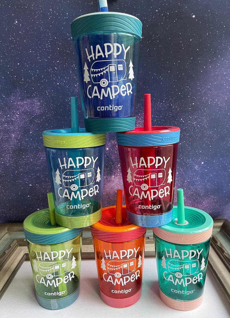 May include: Six colorful, clear plastic cups with straws and lids. Each cup has a white graphic of a camper with the text "Happy Camper" and the brand name "contigo".