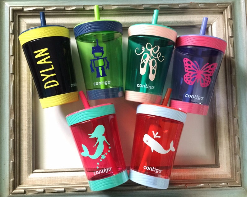 May include: Six colorful, clear plastic cups with straws and different designs. The cups have a black, blue, green, pink, red, and yellow rim. The designs include a robot, ballet shoes, a butterfly, a mermaid, a whale, and the name "DYLAN". Each cup has the word "contigo" printed on the side.