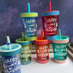 May include: Five colorful, reusable water bottles with straws. Each bottle has a different color and features a white graphic of a camper with the text "Happy Camper" and the brand name "contigo".