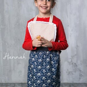 6 year old girl cooking in the kitchen wearing a cute kids apron