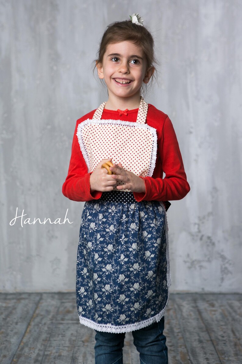 6 year old girl cooking in the kitchen wearing a cute kids apron